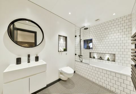 Baño moderno con azulejos monocromos.