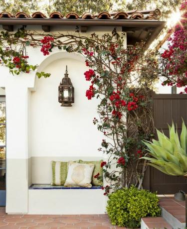 exterior de la residencia de los avergonzados, diseño de interiores por tom callaway detalle del asiento con linterna colgada en la pared blanca y suelo de baldosas