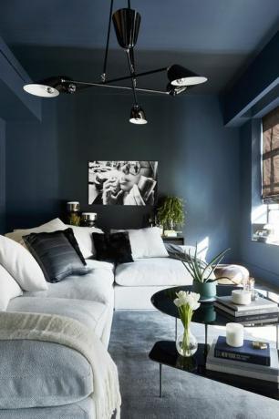 para un efecto ombré, se pintó una sala de entretenimiento en el azul rígido de farrow ball y un sofá con barandillas de designlush chandelier de zia priven