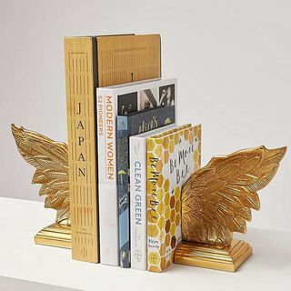 Extremos de libro de oro con alas metálicas