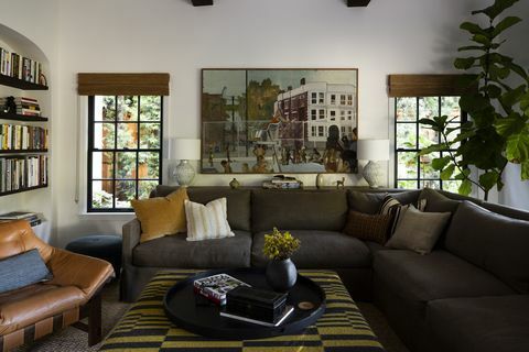 sala de estar, sofá verde, silla de cuero, almohada amarilla, paredes blancas
